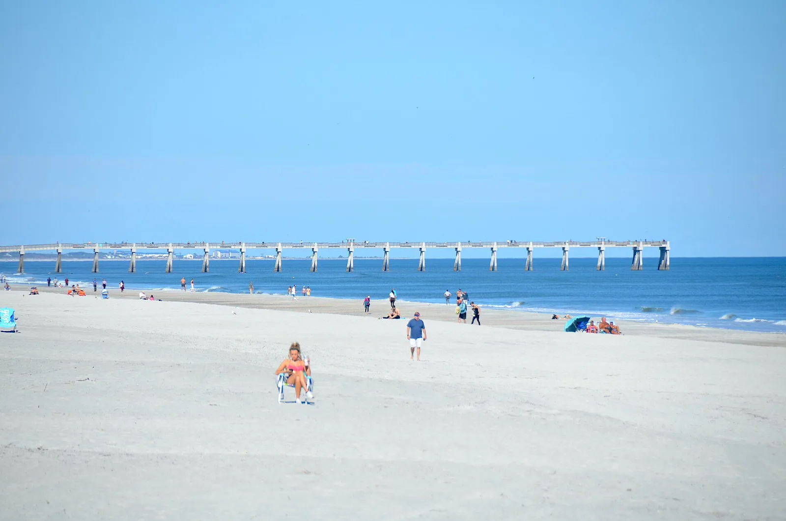 Jacksonville Beach fishing pier extending over the ocean beyond the sandy beach