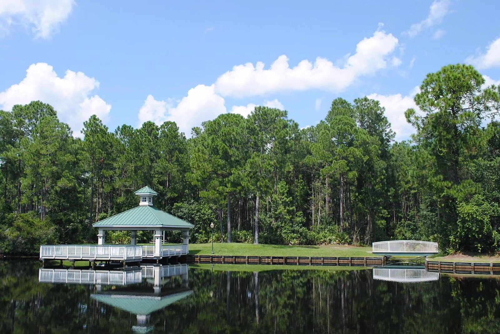 Lakeside gazebo and boardwalk reflected in the water at Julington Creek Park in Fruit Cove, St. Johns, Florida