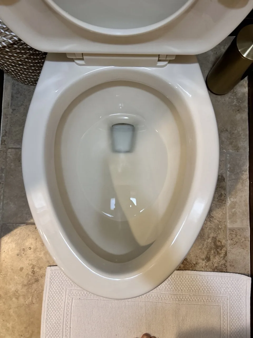 White toilet bowl after cleaning, with the staining removed