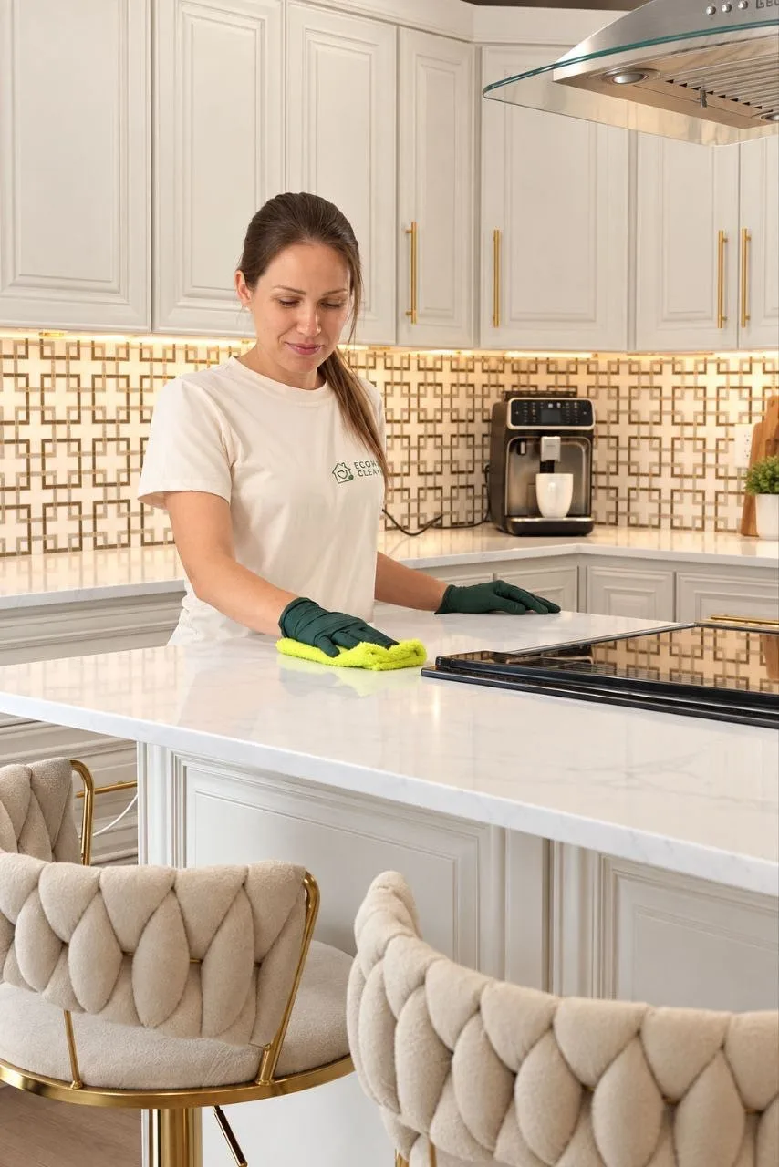 EcoHome cleaner wiping a bright kitchen countertop